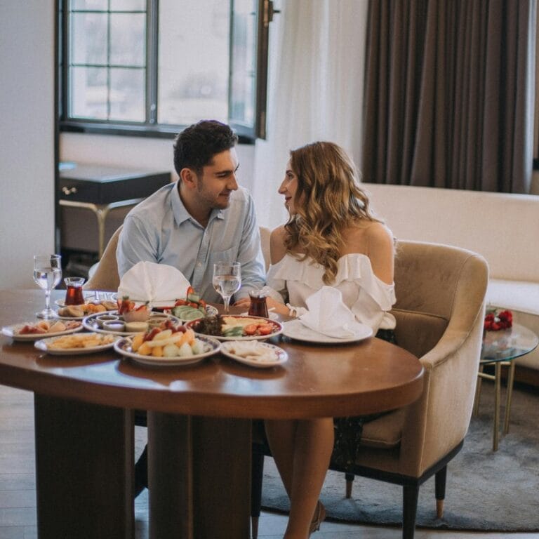 Couple enjoying romantic dinner date at restaurant with candlelight