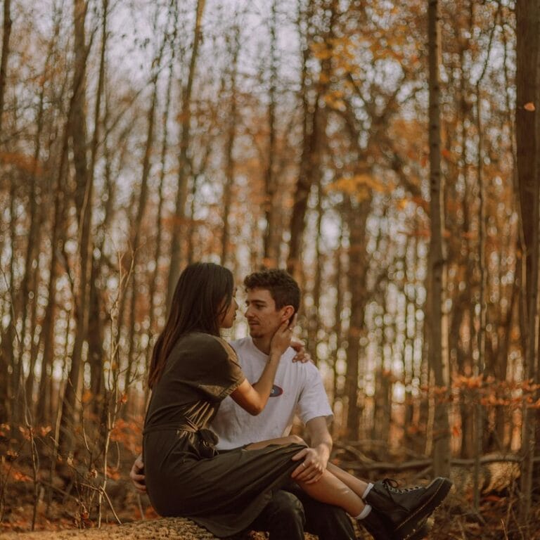 Couple walking together holding hands in autumn park