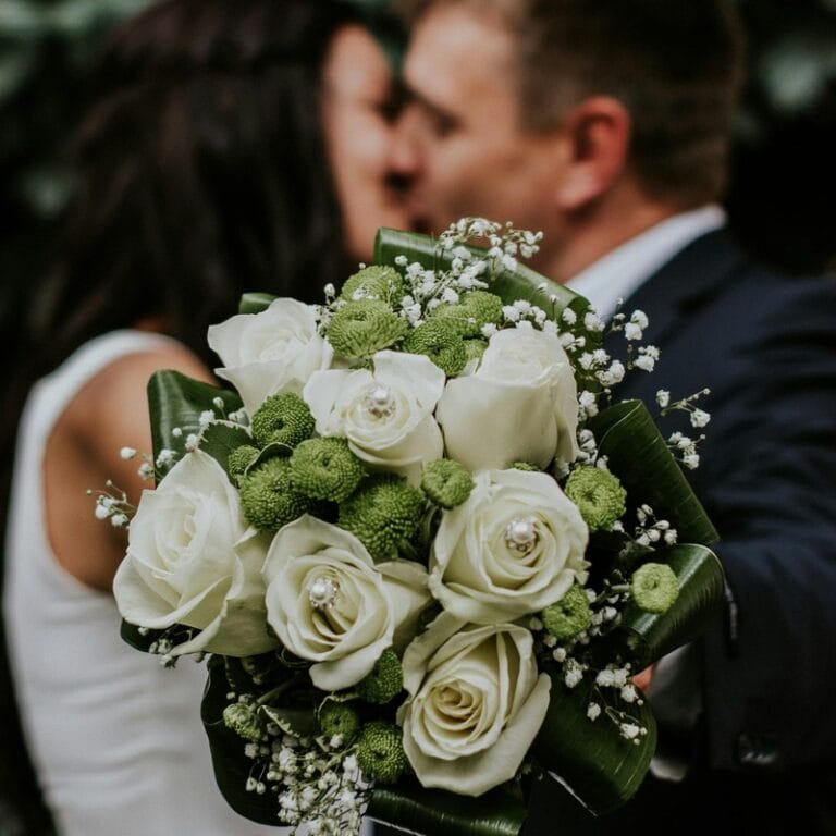 Romantic couple embracing with flowers in a beautiful outdoor setting