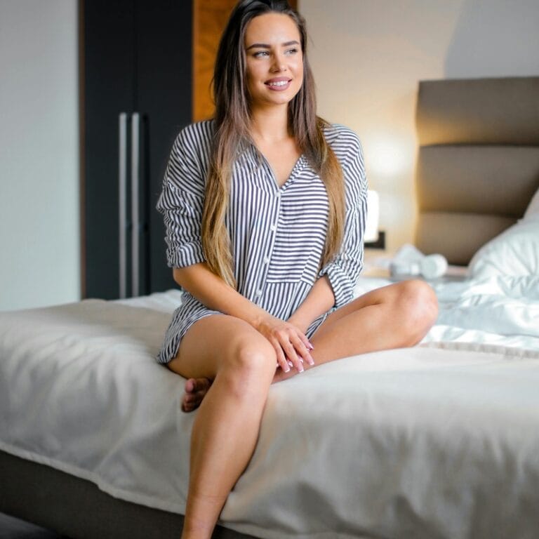 Sensual woman in bedroom wearing lingerie morning light